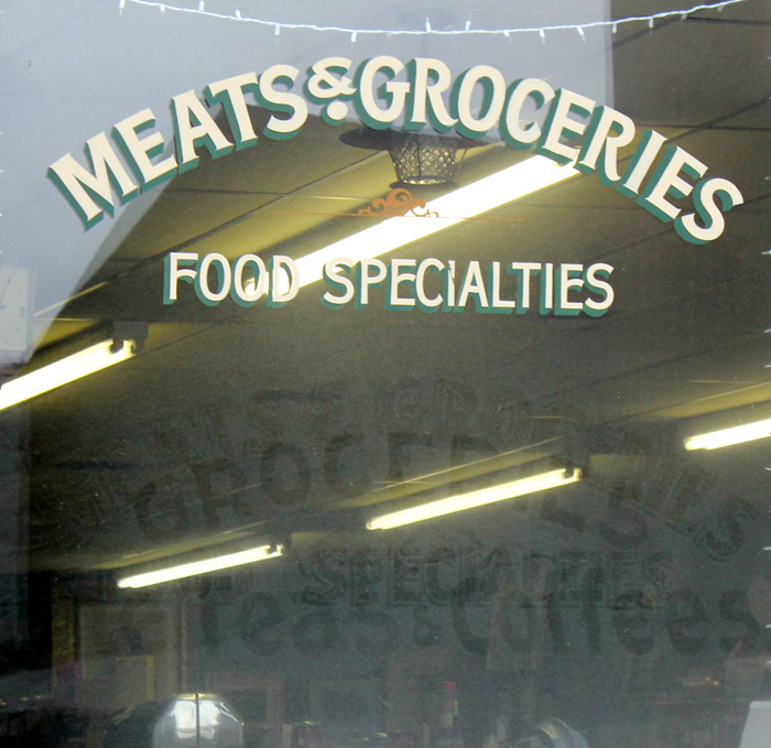 Meats &amp; Groceries window with ghosted sandblasting