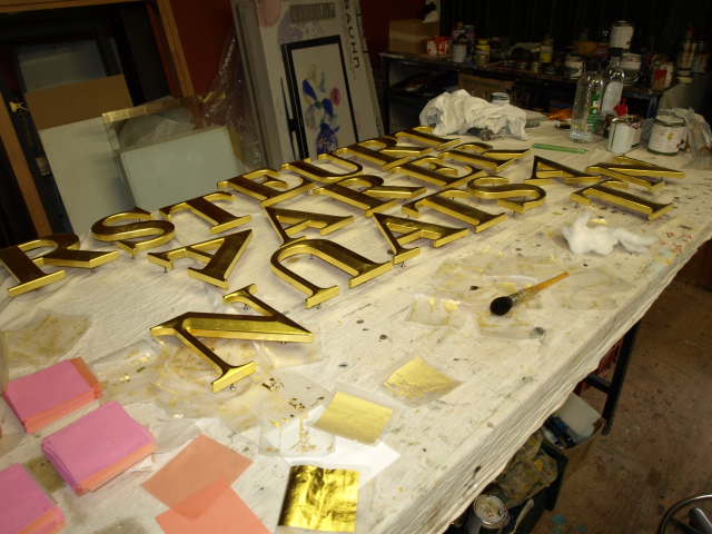 inside my shop, doing some 24ct onto carved acrylic letters.